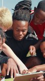 Coach, soccer and clipboard with kids on field for teaching, game plan and tournament strategy. Competition, training and practice with man on outdoor pitch for sports, football player and support - Powered by Shutterstock - Get 15% off with code: PIKWIZARD15