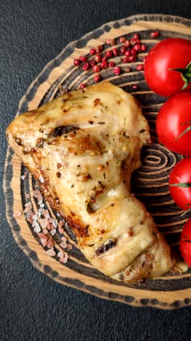 Grilled chicken leg or quarter. Barbecued meat with salt and spices on a ceramic plate