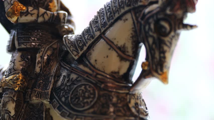 figurine knight in armor on horseback.