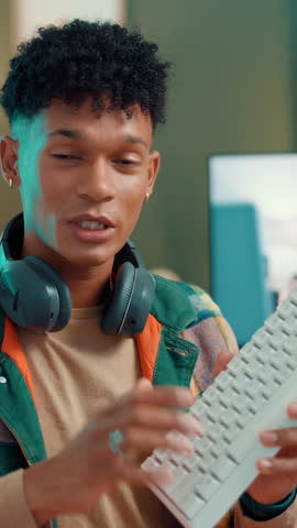 Keyboard, streamer and face of man in studio for gamer channel, sponsorship or tech guide. Product influencer, gaming equipment review and promotion with person in home for recording and social media