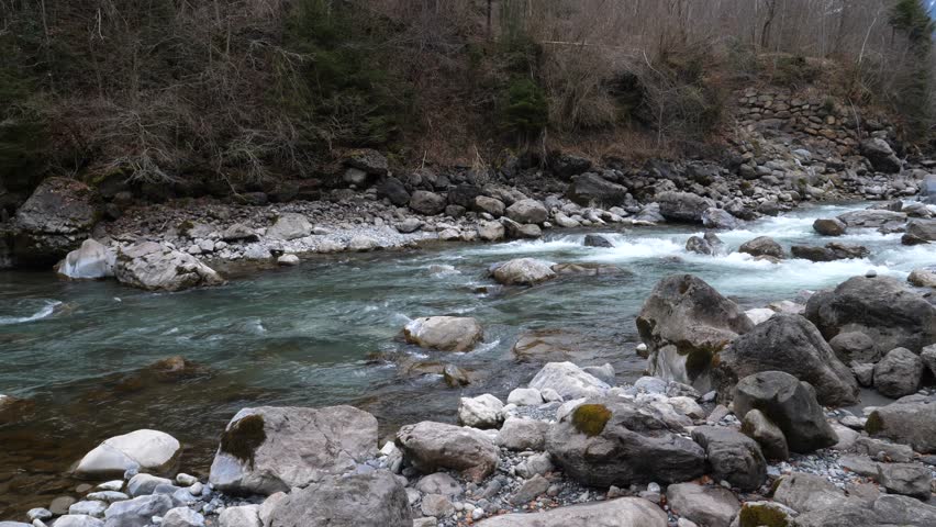 Lauterbrunen, Switzerland - February 12, 2025. the Lütschine River in winter near Lauterbrunen. 