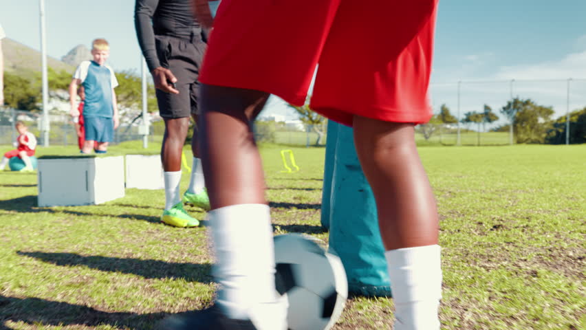 Exercise, drill or soccer with coach and kid on field for ball control, dribbling or training inflatable. Child, fitness and practice with agile football player on sports pitch for skill or technique - Powered by Shutterstock - Get 15% off with code: PIKWIZARD15