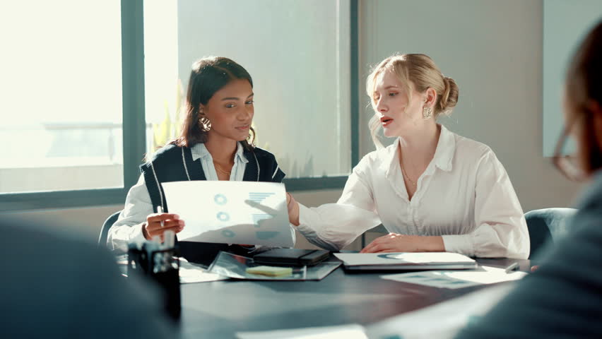 Business people, talking and women in office, documents or charts for budget report. Employees, accounting or financial advisor in meeting, paperwork or planning for profit growth or graphs for audit
