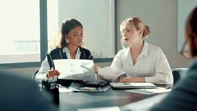 Business people, talking and women in office, documents or charts for budget report. Employees, accounting or financial advisor in meeting, paperwork or planning for profit growth or graphs for audit - Powered by Shutterstock - Get 15% off with code: PIKWIZARD15