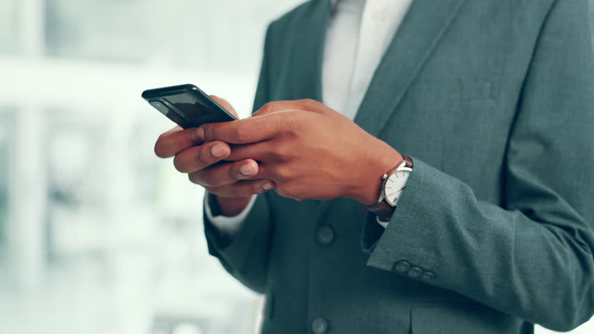 Business, man and hands with phone in office for typing text message, email response or client networking. Financial advisor, employee or smartphone for investment feedback, communication or research