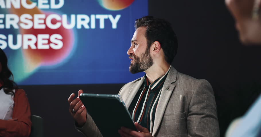 Tablet, presentation and business people in discussion on a stage for enhanced cybersecurity measures. Meeting, technology and team of malware analysts with planning for website encryption system.