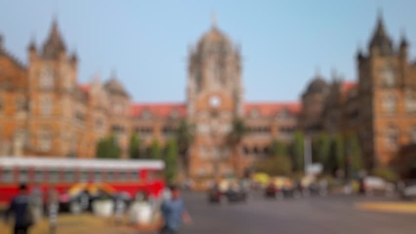 Bokeh view of road traffic near CSMT (Chhatrapati Shivaji Maharaj Terminus) railway station, Mumbai, India. Blurred background footage.