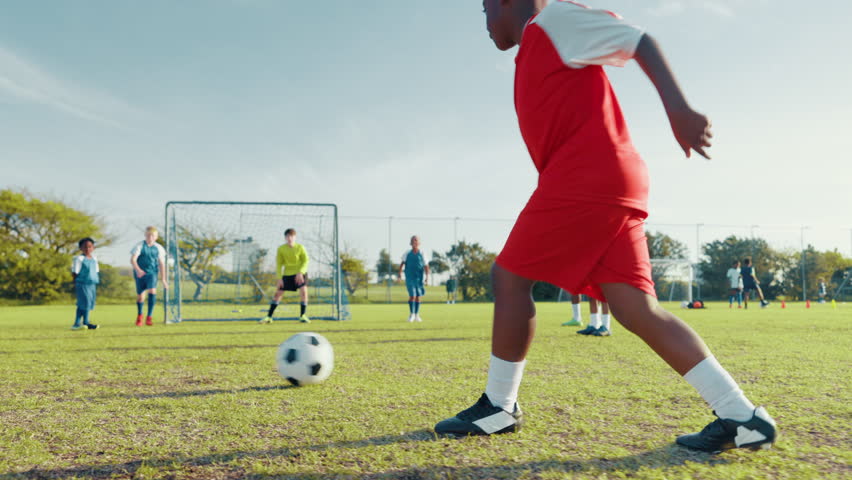 Soccer, players and goal with ball on grass field for score, match or outdoor game on pitch. People, kids or children playing football with team pass, attack or defense for tackle, strike or shot