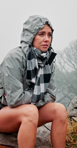 Lost, nature and woman with hiking in cold for travel crisis, mistake or bad weather on holiday. Outdoor, upset and confused female person on tree trunk for trekking error in winter in forest.