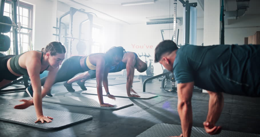 Side plank, people and trainer in gym, fitness and training with endurance, challenge and motivation. Group, instructor and men with women, exercise and support in wellness center, workout or healthy