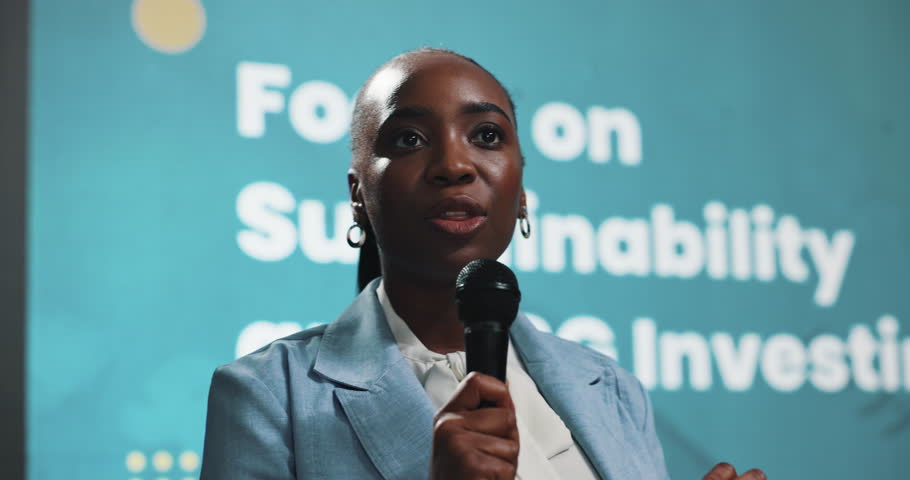 Presentation, speech and stage with business black woman in auditorium for financial sustainability. Conference, development and symposium with African speaker on podium for finance or investment