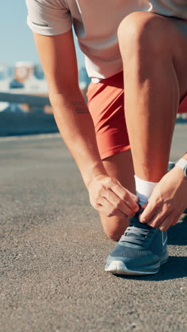Hands, athlete and tie shoes in road to start running, exercise preparation and marathon training in city. Fitness, person and getting ready with sneakers on bridge for sports workout and performance