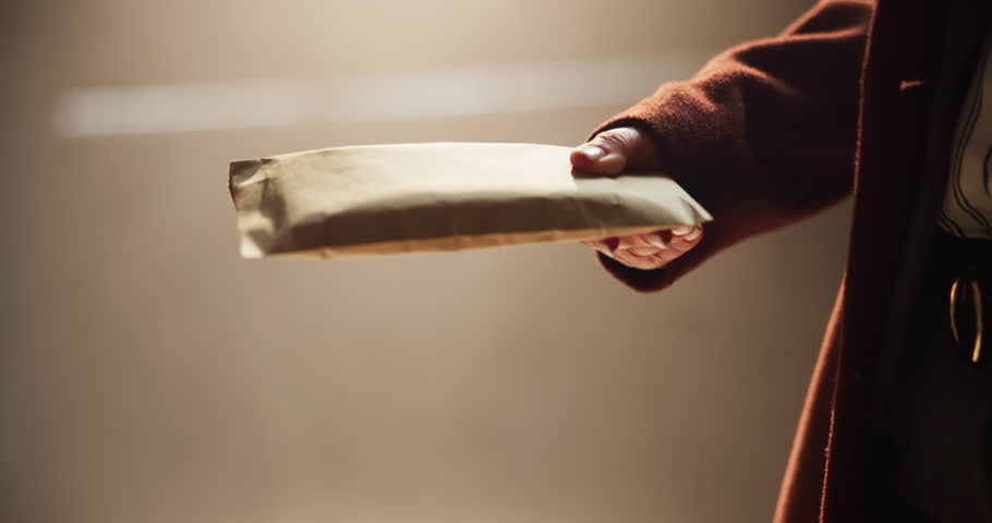 People, bribery or hands with payment for scam, money laundering or settlement in crime syndicate. Workplace, night or closeup of fraud exchange in corruption, brown paper bag or illegal business