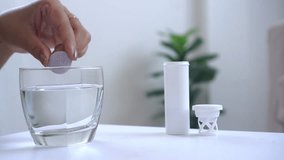 a woman’s hand putting effervescent tablets into a glass of water, showing the idea of taking vitamins, supplements, or medicine to support health, boost energy, or get relief from sickness - Powered by Shutterstock - Get 15% off with code: PIKWIZARD15