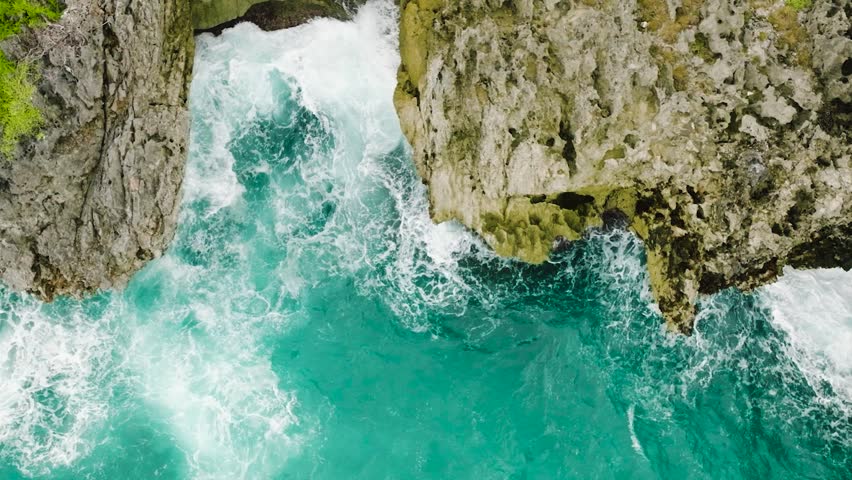 Water waves hitting on rocks, beautiful scenery in Boracay, Philippines.