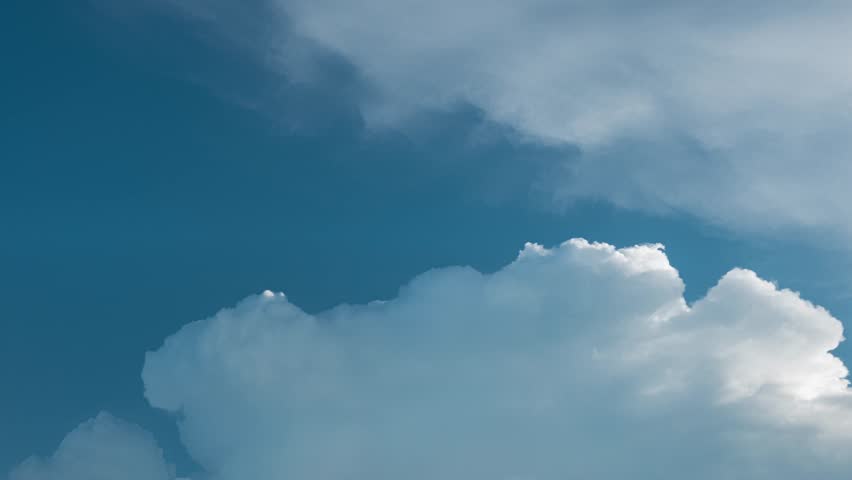 Time-lapse of clouds moving across a blue sky during daylight creating a dynamic atmosphere