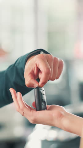 Hands, buyer and salesman with keys at car dealership for vehicle purchase, hiring success and test drive. Showroom, person and deal with driver for automobile collection, rental agreement and offer