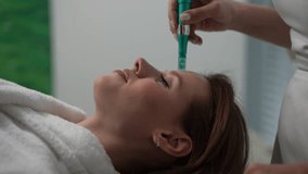 Cropped shot of professional beautician performing microneedling treatment with dermapen on female patient forehead, targeting skin rejuvenation enhancing collagen production, close-up, slow motion - Powered by Shutterstock - Get 15% off with code: PIKWIZARD15