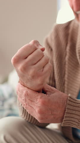 Hands, senior man and wrist pain in home with arthritis, inflammation and carpal tunnel syndrome. Pensioner, elderly person and massage joint with osteoporosis, fibromyalgia risk and muscle tension