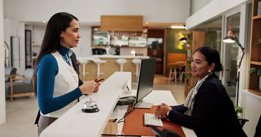 Hotel, reception and couple with passport for check in, reservation and honeymoon accommodation. Hospitality industry, concierge service and people with arrival for holiday booking and confirmation