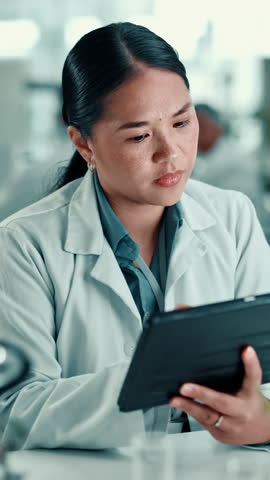 Serious, scientist and woman with tablet, lab or medical research for cancer cure, review or online. Clinic, oncologist and person with tech for analysis, diagnosis and digital records for illness