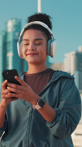Phone, fitness and woman with headphones in city for music, streaming podcast and laughing at meme. Happy athlete, mobile and outdoor for sound, song and runner listening to audio on exercise break
