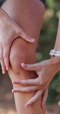 Outdoor, runner and person with knee injury, accident or legs with joint pain, inflammation or ache. Swollen, athlete and muscle strain in nature, fitness and massage for tension, sore or broken bone