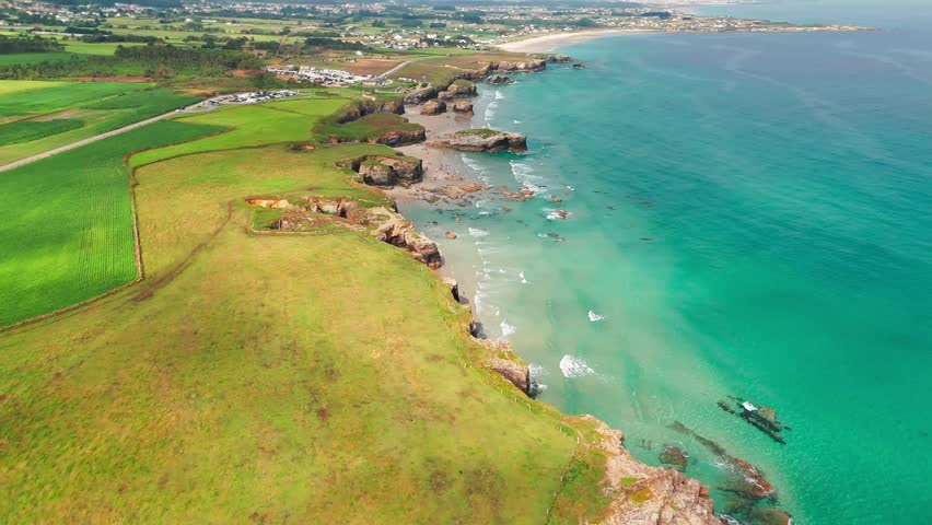 Amazing aerial view of the Playa de Las Catedrales beach in Galicia region at sunset, northern Spain. Beautiful cliff formations on famous Cathedral Beach, Cantabrian Coast 