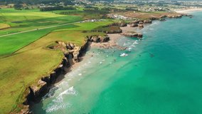 Amazing aerial view of the Playa de Las Catedrales beach in Galicia region at sunset, northern Spain. Beautiful cliff formations on famous Cathedral Beach, Cantabrian Coast  - Powered by Shutterstock - Get 15% off with code: PIKWIZARD15