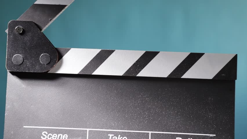 Movie scene setup, action board clapping, creating a cinematic effect with flying chalk dust