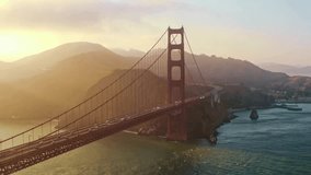 Golden Gate Bridge stands majestically against sunset backdrop. Warm light fills sky, reflecting on water below. Scenic journey captures travel essence of San Francisco's charm. - Powered by Shutterstock - Get 15% off with code: PIKWIZARD15