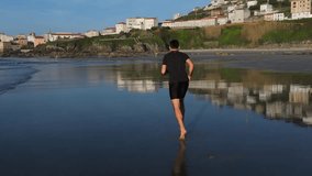 Man Running Barefoot On The Shores Of Praia de Caion In A Coruna, Spain. Slow Motion Shot - Powered by Shutterstock - Get 15% off with code: PIKWIZARD15