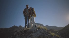 Professional mountaineers working together, climbing steep rocky terrain with trekking poles, displaying remarkable partnership and determination during challenging alpine expedition - Powered by Shutterstock - Get 15% off with code: PIKWIZARD15