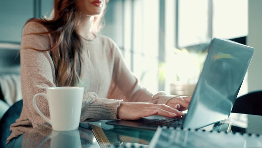 Hands, laptop and typing with coffee for remote work at home for information, research and writing. Woman, tea and technology with book author for freelancing and publishing content online on website - Powered by Shutterstock - Get 15% off with code: PIKWIZARD15