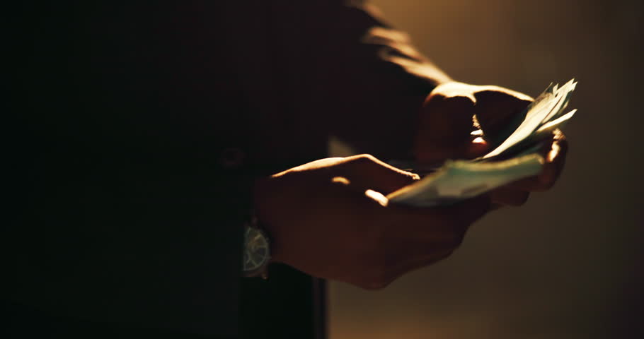 Hands, fraud and counting cash for profit, money laundering and investment scam in crime syndicate. Night, bank notes and person with wealth from criminal activities, corruption and illegal business