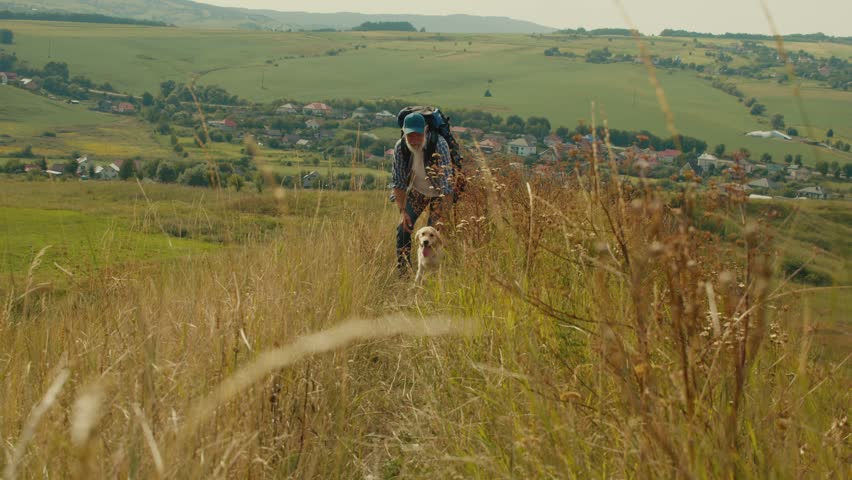 Therapeutic Hiking, Natural Rehabilitation. Senior Man With Backpack Treks Through Mountains With His Dog. A Calm, Healing Journey of Mobility Recovery and Outdoor Wellness After Retirement