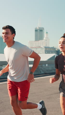 City, people and fist bump for running, wellness challenge and training for marathon on bridge. Woman, man and friends workout with endurance for exercise, cardio and morning jog on road with fitness