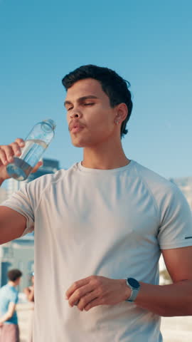 Drinking water, break and man in city for marathon training, runner health and cardio fitness. Hydration, athlete and challenge with energy in street for sports exercise, workout and wellness