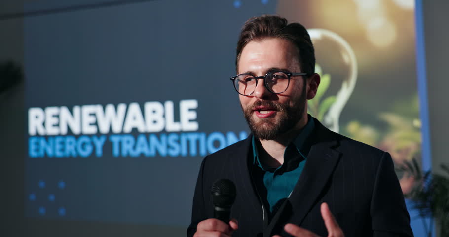 Speaker, seminar and man with microphone for sustainability with renewable energy transition. Male leader, convention or conference for learning of climate change, innovation or environment on screen