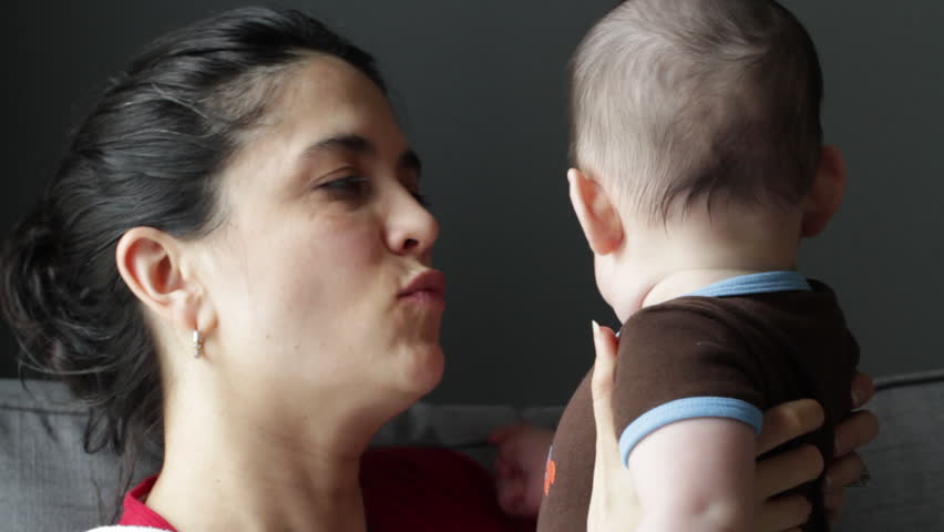 Mother kisses her baby boy (four months' old).