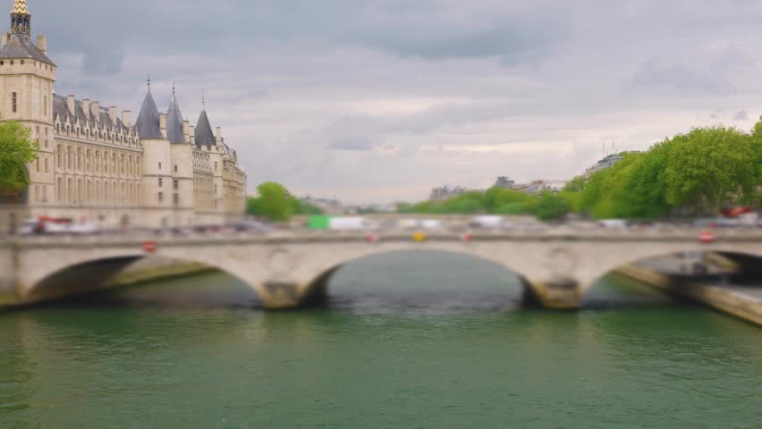 View of the bridge Pont au Change over the Seine River, island Ile de la Cit and the Conciergerie in 1st arrondissement, Paris, France. Out of focus.