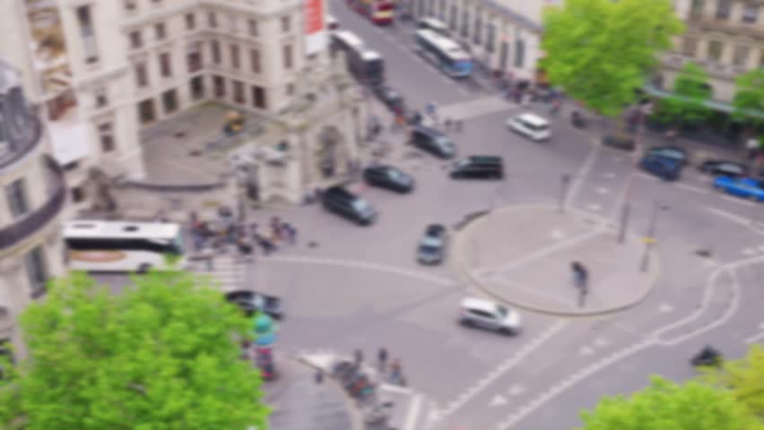 Panoramic top view of the traffic on Place Diaghilev from the free observation deck on the roof of the Galeries Lafayette. Place Diaghilev (La place Diaghilev). Out of focus. Paris, France.