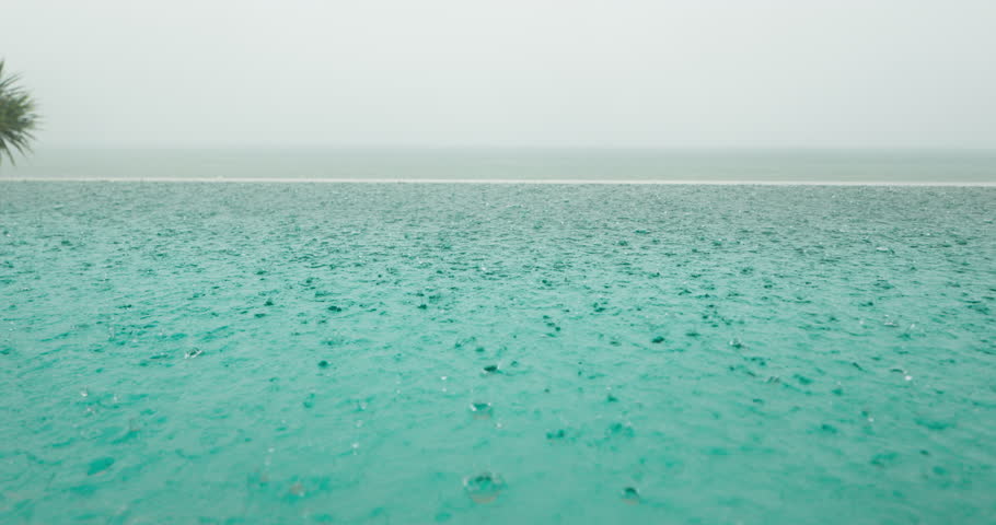 luxury villa with pool during heavy rain, balconies, palm trees on the beach, nobody, view from terrace on the beach, blue sea and islands in the background