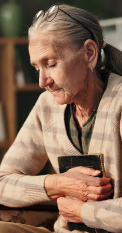 Depression, photograph and sadness with senior woman in retirement home for loss or nostalgia. Grief, memory or thinking and old person with picture in apartment for loneliness, mistake or regret