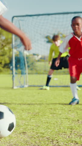 Boys, kids or soccer player with skill or goal for win at game or match in youth tournament. Sports, nutmeg or back of football athlete shooting ball in net at target practice on field at stadium