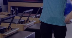 Woman lifting arm to start side-stretch in Pilates studio with fitness overlay tracking flexibility. Fitness, health, wellness, exercise, modern, vitality, mobility - Powered by Shutterstock - Get 15% off with code: PIKWIZARD15