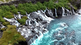 Discover the stunning cascades of Barnafoss and Hraunfossar, where crystal-clear waters flow effortlessly over unique lava formations amidst lush greenery in Icelands captivating landscape. - Powered by Shutterstock - Get 15% off with code: PIKWIZARD15