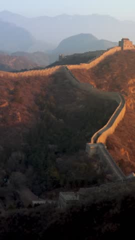 Flying over the Great Wall of China at sunrise. Vertical Video,