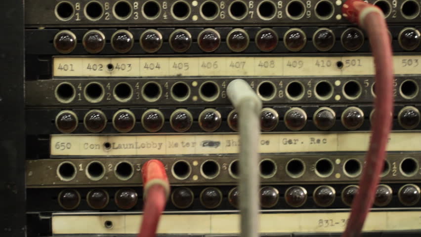 Camera dollies across the cables and sockets on an old telephone switchboard.