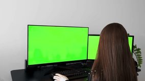Woman Working at Desk with Dual Monitors – Green Screen Setup - Powered by Shutterstock - Get 15% off with code: PIKWIZARD15